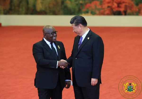 China's Xi Jinping (r) welcoming Akufo-Addo (l) to China for an official state visit