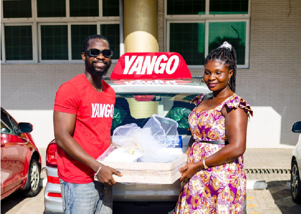 A benefeciary receiving a gift from Yango
