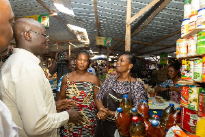 Ato Forson (L) engaging traders at the market