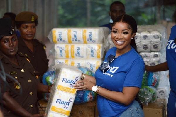 Brand Ambassador for Flora tissue presenting an item to one of the officers