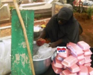 The unknown woman was spotted at the cemetery busily packaging cooked rice in takeaway packs