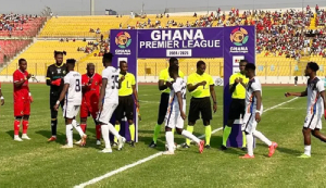 Image of Asante Kotoko and Hearts of Oak (in white) players exchanging pleasantries before kickoff