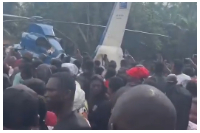 Residents gather as helicopter carrying Ernest Kumi's body lands in Akyem-Wenchi