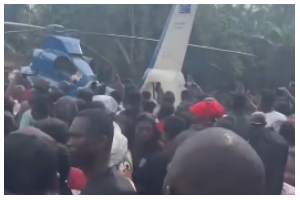 Residents gather as helicopter carrying Ernest Kumi's body lands in Akyem-Wenchi