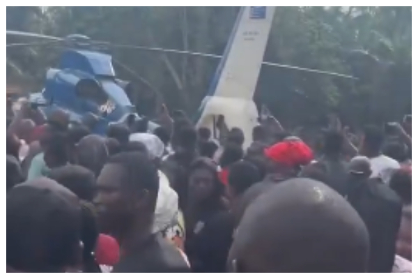 Residents gather as helicopter carrying Ernest Kumi's body lands in Akyem-Wenchi