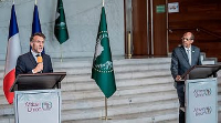 Mahmoud Ali Youssouf and Emmanuel Macron speak at the AU headquarters in Addis Ababa