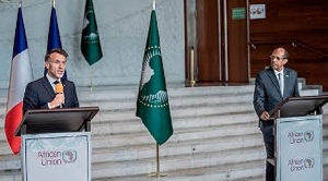 Mahmoud Ali Youssouf and Emmanuel Macron speak at the AU headquarters in Addis Ababa