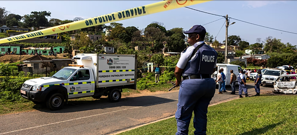 A police officer is seen at a scene of a mass shooting at a house party in KwaMakhutha township