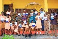 Queen Mother and elders of Morso Traditional area join students to receive books from Eric Amofa