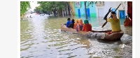 Following heavy rains, people used boats to get around the Somali town of Bardere