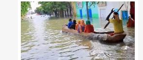 Following heavy rains, people used boats to get around the Somali town of Bardere