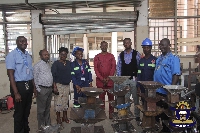 Students (in safety helmets) with KsTU registrar and other senior staff | Photo supplied