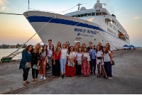 A picture of some Semester at Sea students in front of MV World Odyssey