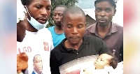 One of the babies with community members