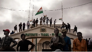 Protesters hold a Niger flag during a demonstration on independence day in Niamey on August 3, 2023.