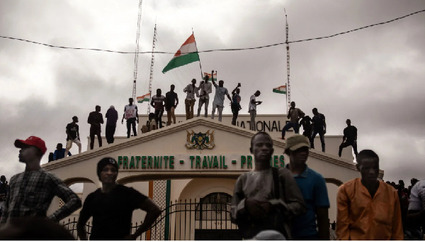 Protesters hold a Niger flag during a demonstration on independence day in Niamey on August 3, 2023.