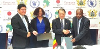 The Japanese Ambassoador, Mr Tsutomu Himeno (2nd R) exchanging document with Mr. Agyemang Manu