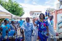 Alma Adade-Prempeh waving at some people