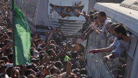 People gather to greet freed Palestinian prisoners arriving on buses in the Gaza Strip