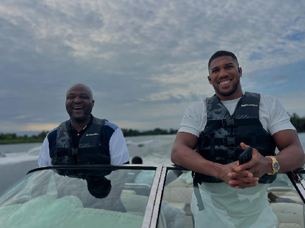 Ibrahim Mahama (L) and Anthony Joshua (R) cruising in a speed boat