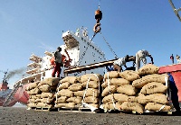 Cocoa beans being loaded onto a ship