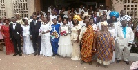 The couples in photograph with the clergy and their loved ones