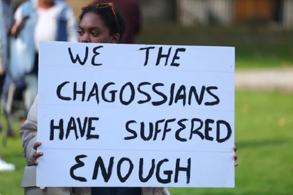 One protestor with a placard / photo credit: Reuters
