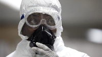 A medical technician works inside a mobile lab set up to test rapidly for Ebola virus in Butembo
