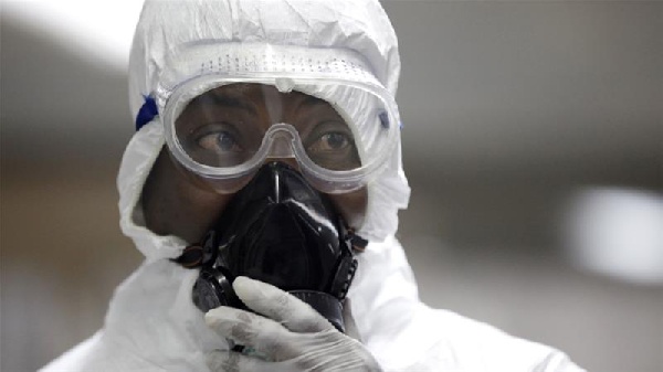 A medical technician works inside a mobile lab set up to test rapidly for Ebola virus in Butembo