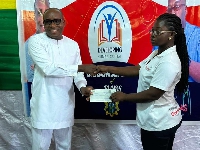 A beneficiary receiving a cheque from the DCE