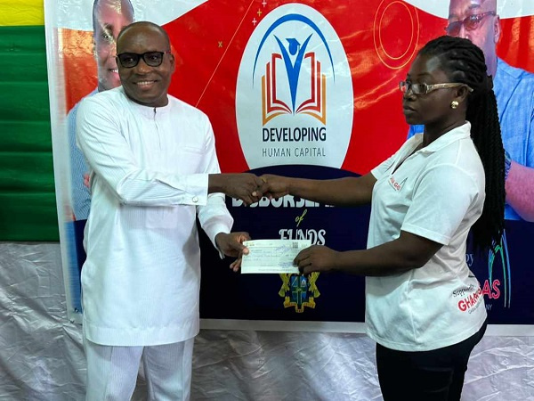A beneficiary receiving a cheque from the DCE