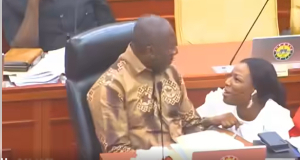 Prof Ayensu-Danquah squatting in front of Afenyo-Markin as they laughed and chatted