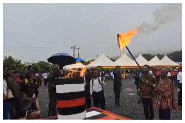 Kimathi Rawlings and Asiedu Nketiah (holding stick) lighting the revolutionary flame at Agormanya