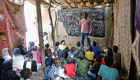 Sudanese teacher Mabrouk Non, who left Sudan during the civil war, teaches at a refugees school