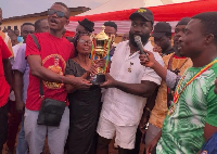 Okatakyie Afrifa-Mensah and the mother of the late Baba Amando presenting the trophy