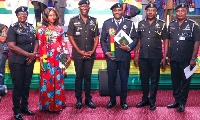 IGP Dr Akuffo Dampare with the two officers in a picture