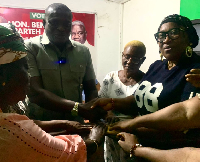 Bernard Martei Korley presenting the money to the women