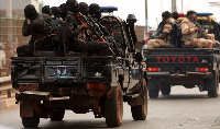Soldiers patrol on a main road in Bissau