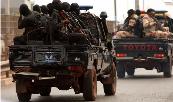Soldiers patrol on a main road in Bissau