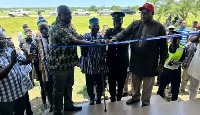 Photo of a tape cutting ceremony of a police post at Kokoligu