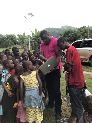 John Dumelo with some children