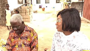 Veteran actor Paa George chatting with Gloria Sarfo during her visit
