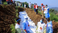 Congolese Red Cross buries victims of M23 rebel clashes in a mass grave