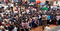 An image of military personnel beating persons who massed up to register