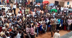 An image of military personnel beating persons who massed up to register