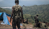 Armed Forces of the DRC soldiers dig trenches at a frontline military position above the town of Ki