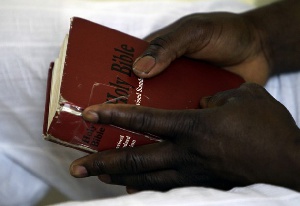 Man holds a bible.         File photo.