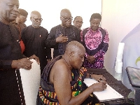 Nana Otu Siriboe II signing the book of condolence