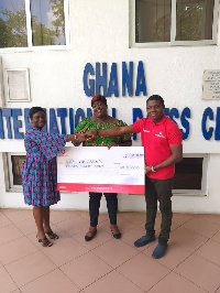 Ebenezer Amankwah [R], Corporate Relations Manager at Vodafone Ghana presenting the cheque