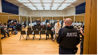 A judicial officer waits for the beginning of a landmark trial on April 29, in Stuttgart, Germany.